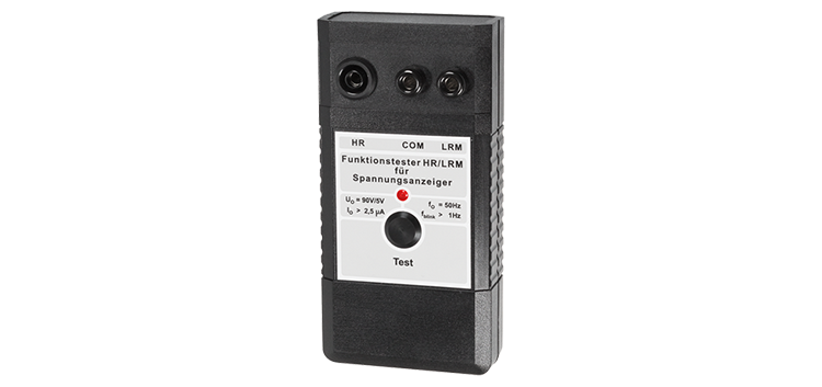 Electronic, black function tester with red LED display, several connection sockets, typically used for testing and diagnosing electrical devices and components.